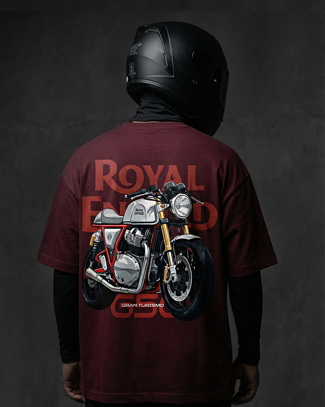Person wearing a maroon t-shirt with a motorcycle graphic and 'Royal Enfield' branding on the back, against a dark background.