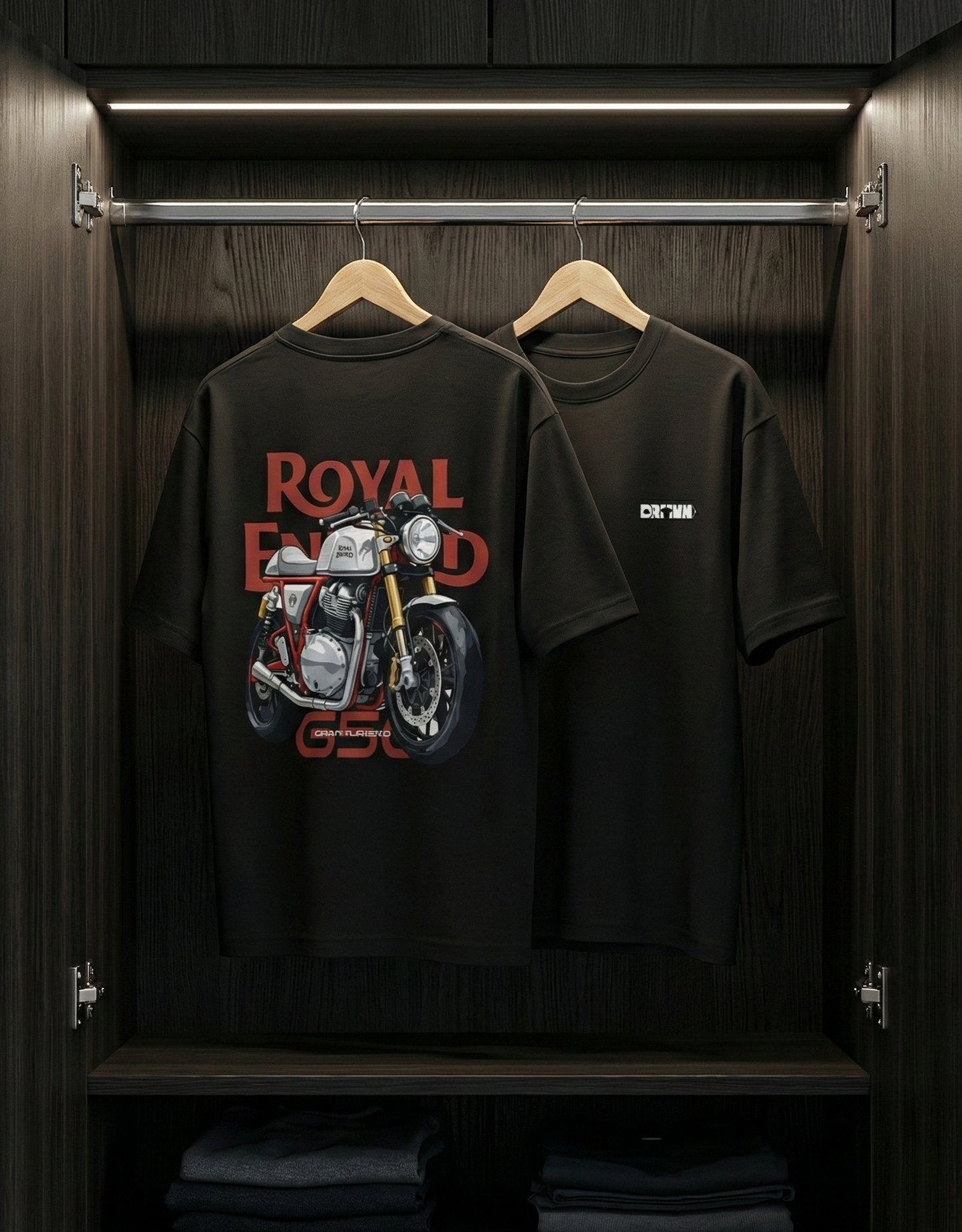 Black t-shirt with 'Royal Enfield' logo on a hanger inside a wooden wardrobe.