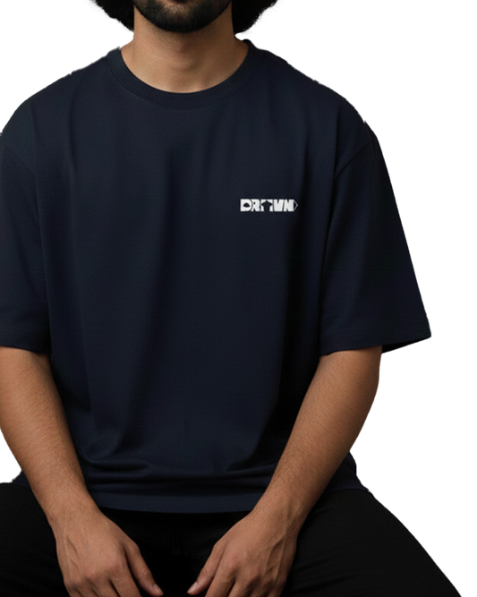 Person wearing a black t-shirt with a logo of drivnwear