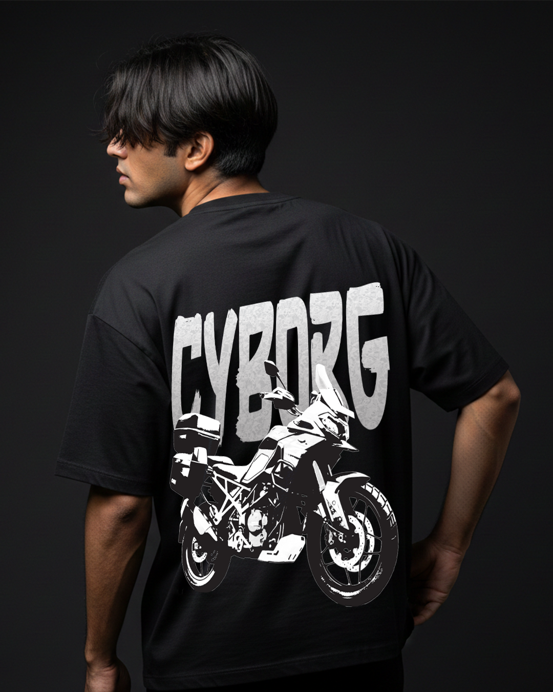Person wearing a black t-shirt with a motorcycle graphic and 'CYBORG' text on the back against a dark background.