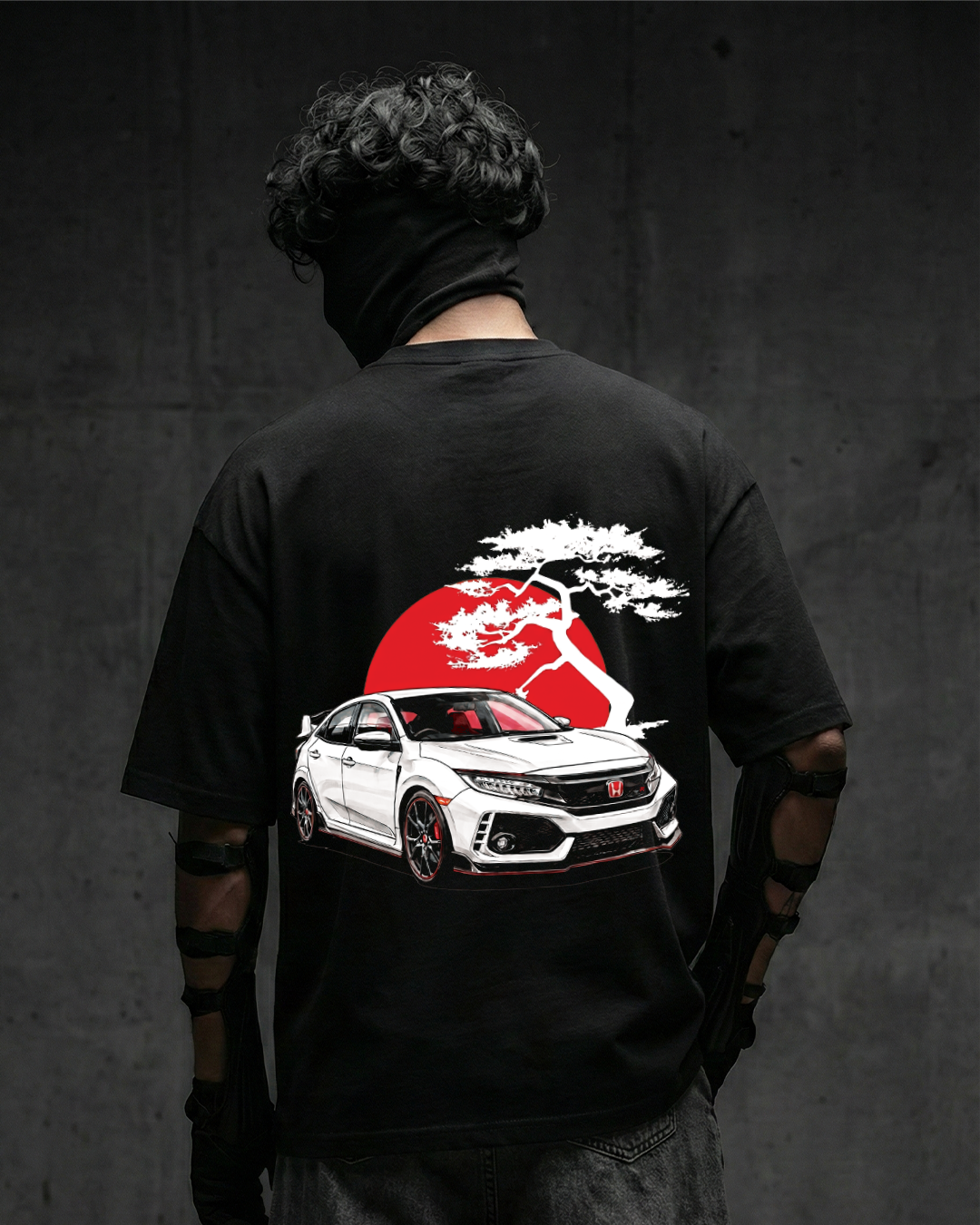 Person wearing a black t-shirt with a honda civic r graphic and red sun design on the back, against a dark background.