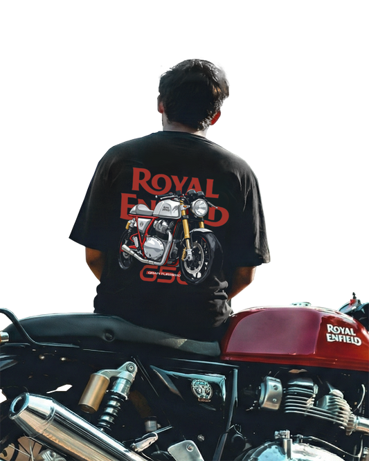 A man sitting on a royal enfield gt 650 wearing a gt650 oversized tshirt from drivnwear
