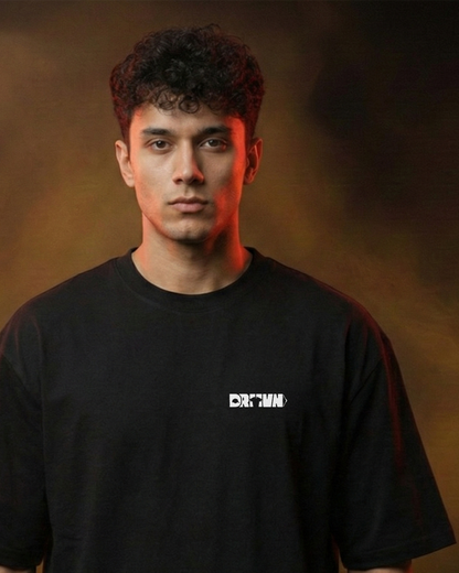 Person wearing a black t-shirt with drivnwear logo against a brown background