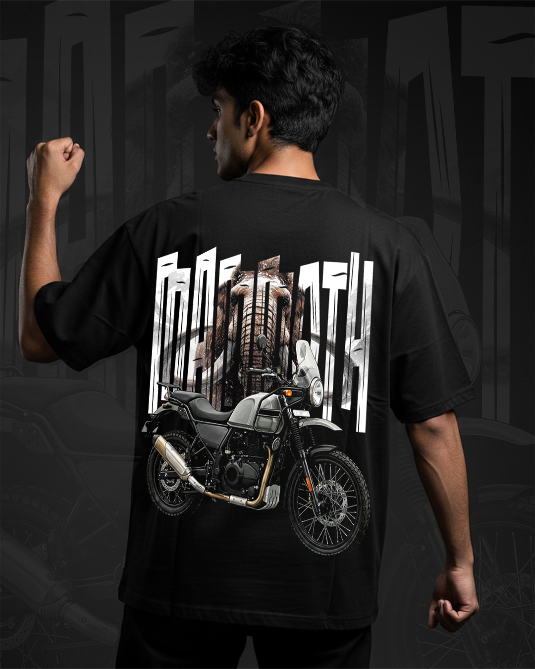 A man wearing a black oversized tshirt with mammoth himalayan bike themed graphics