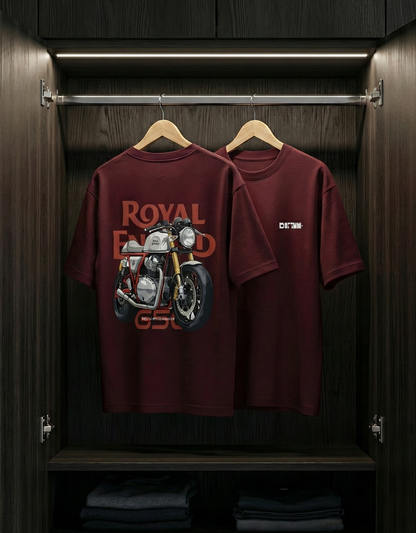 Two maroon t-shirts with motorcycle graphics hanging in a wooden wardrobe.