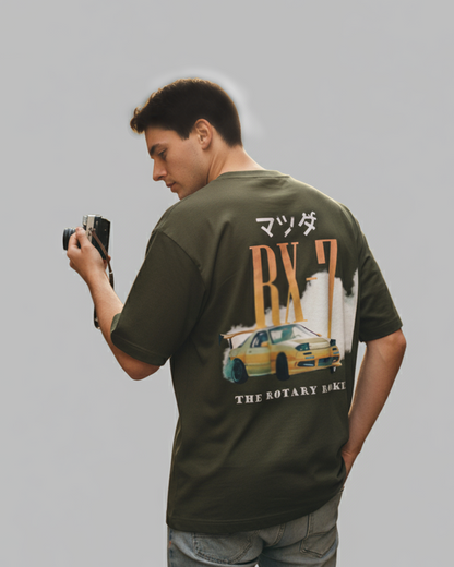 Man wearing a green t-shirt with a car graphic and text on a gray background