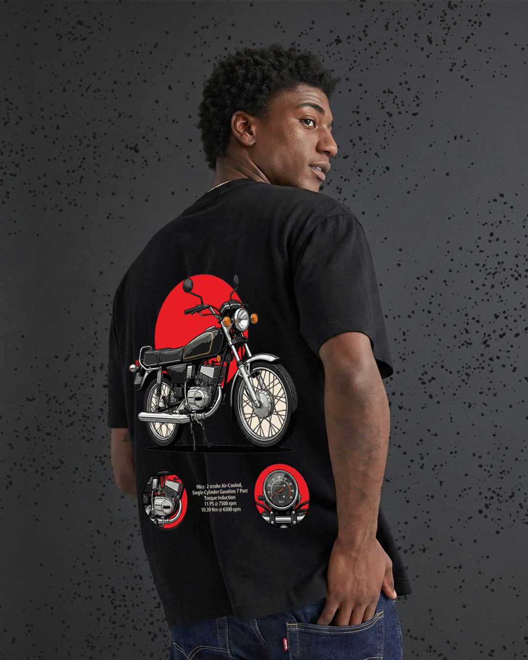 Person wearing a black t-shirt with a motorcycle graphic on the back against a dark textured background