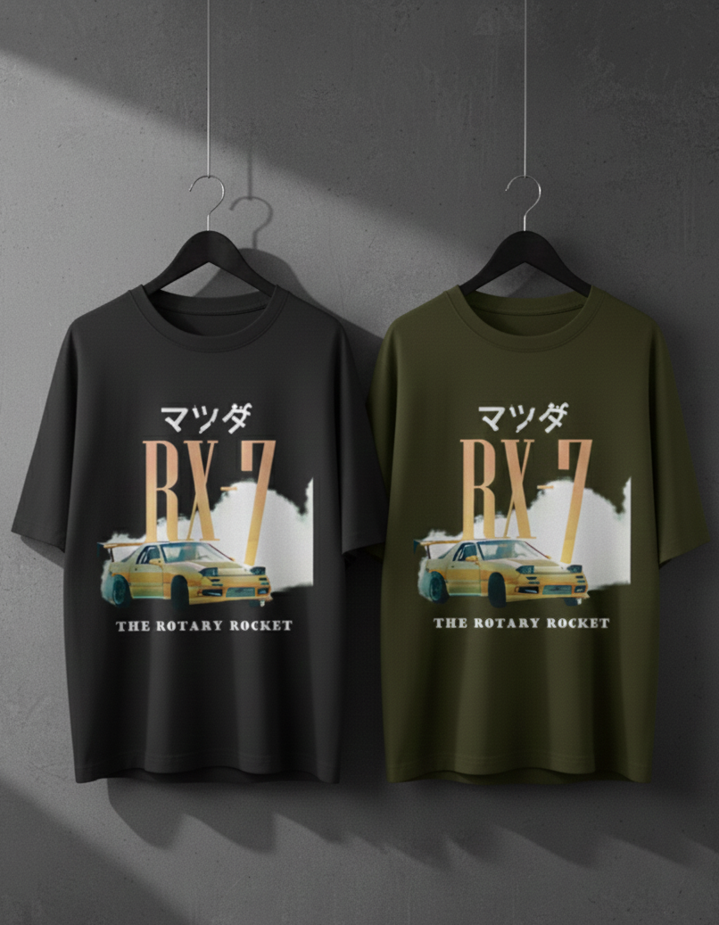 Two Mazda RX-7 t-shirts on hangers against a gray background