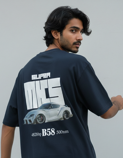 Man wearing a navy blue t-shirt with a graphic design on the back against a gray background