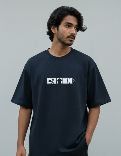 Man wearing a black t-shirt with drivn logo on a gray background