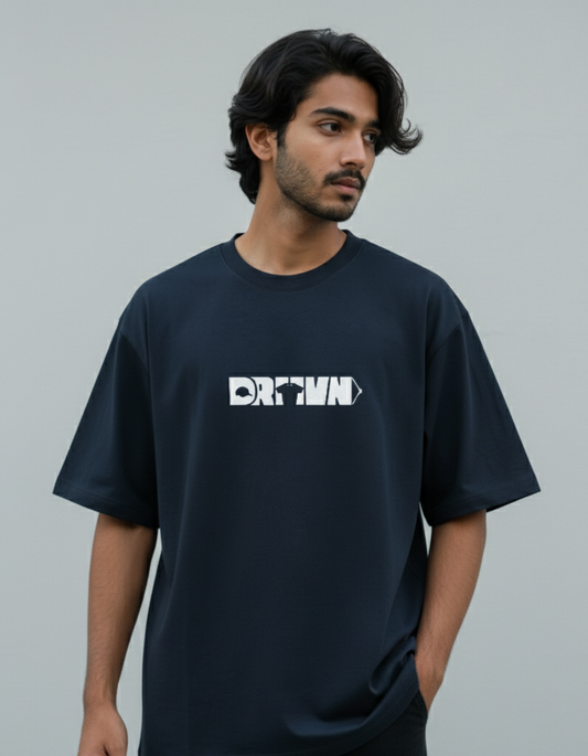 Man wearing a black t-shirt with drivn logo on a gray background